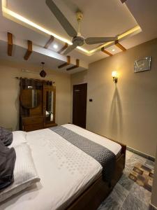 a bedroom with a bed and a ceiling fan at Travellers Home 2BR Portion Gulshan Iqbal blk 7 in Karachi