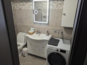 a bathroom with a sink and a washing machine at Tsitsipas Apartment in Alexandroupoli +45 photos
