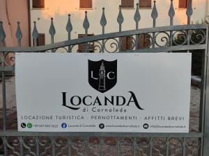 a sign for a restaurant on a fence at Locanda di Cornoleda in Cinto Euganeo