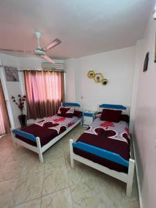 a bedroom with two beds and a ceiling at Golden beach 2 Ras sedr Cozy chalet in Ras Sedr