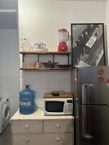 a kitchen with a microwave and a refrigerator at Apartment in IPANEMA in Rio de Janeiro