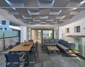 a living room with a couch and tables at Villa Paradisio 2, Pool, Sea View in Hanioti