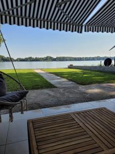 a porch swing with a view of a lake at MR residence in Kovin
