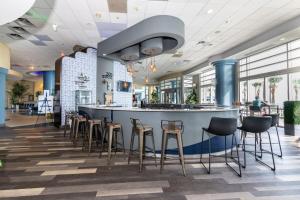 een bar in een restaurant met krukken bij Oceanfront Bliss 3BR Direct Ocean Front Retreat on the 4th Floor at The WyndhamOcean Walk Resort in Daytona Beach