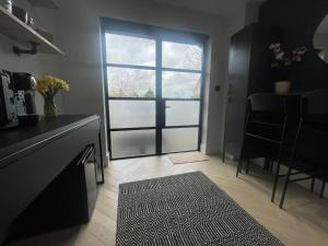 a kitchen with a sliding glass door with a table at The Nook @ Winchester. in Winchester