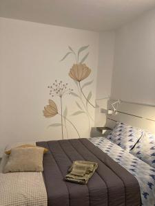 a bedroom with a bed with a flower mural on the wall at La casetta in Cuneo