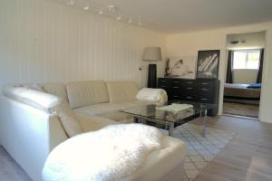a living room with a white couch and a table at Spacious apartment in Sarpsborg