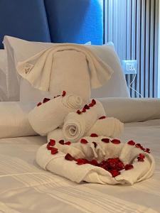 a pile of towels sitting on top of a bed at Elite Pyramids Boutique Hotel in Cairo