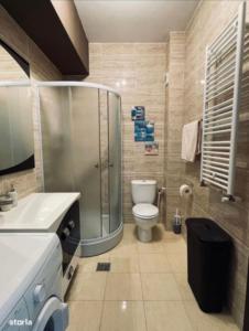 a bathroom with a shower and a toilet and a sink at ZENSTAY SUMMERLAND MAMAIA in Mamaia