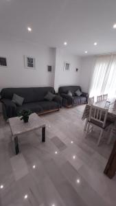 a living room with a couch and a table at Brisas del Guadalquivir in Sanlúcar de Barrameda