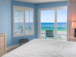 a bedroom with a bed and a view of the ocean at blu #606 Luxury 2 Bd Beachfront Condo in Fort Walton Beach
