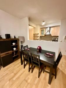 a kitchen and dining room with a table and chairs at City center apartment with balcony in Budapest