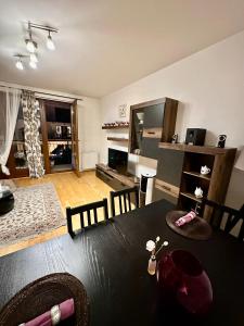 a dining room with a table and a living room at City center apartment with balcony in Budapest