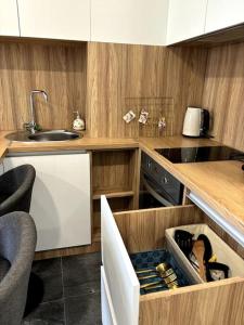 a kitchen with a sink and a counter with a drawer at Central Park Apartment in Chişinău