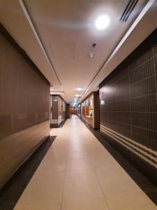 a hallway of a building with a long corridor at 1Bedroom Furnished Apartment in Dubai