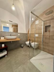 a bathroom with two sinks and a glass shower at Eco Garda Hill in Tenno +50 photos