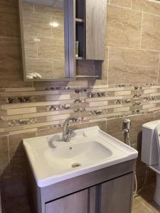 a bathroom with a sink and a mirror at Desert Elegance Luxury Bedouin Camp Panoramic View in Disah +88 photos