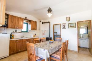 a kitchen and dining room with a table and chairs at House Marta in Kraj +15 photos