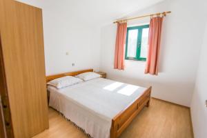 a bedroom with a bed and a window at House Marta in Kraj
