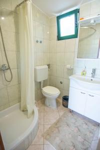 a bathroom with a toilet and a sink and a shower at House Marta in Kraj