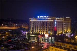 a large building with lights on it at night at GuangZhou TongYu International Hotel in Guangzhou