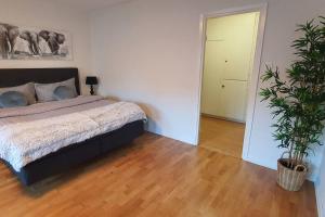 a bedroom with a bed and a potted plant at Apartment with garden near metro! in Stockholm