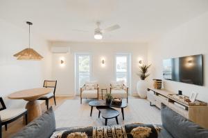 a living room with a couch and a table at The Lumina at The Tarrymore in Wrightsville Beach