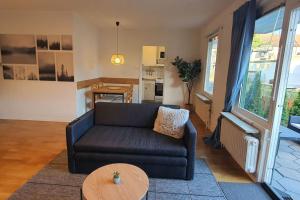 a living room with a couch and a table at Apartment with garden near metro! in Stockholm