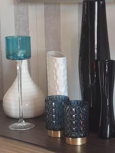 a group of vases and a glass on a shelf at Ferienhaus für 8 Personen und 2 Kinder in Kiczora, Schlesien in Milówka