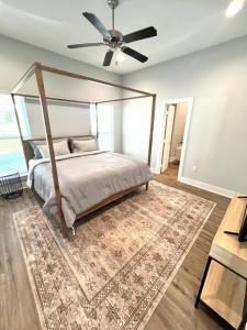1 dormitorio con cama con dosel y alfombra en Coastal Oasis en Gulfport