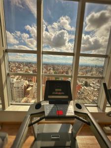 a room with a treadmill in front of a large window at Simplemente DUOMO in Córdoba