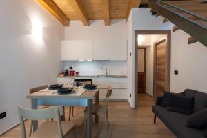 a kitchen and living room with a table and chairs at Ottavio's House by RentMax, 10min from Maggiore Lake in Ornavasso