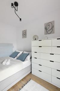 een slaapkamer met een wit bed en een dressoir bij Malila Premium Apartments Cracow City Center Pawia 34 in Krakau