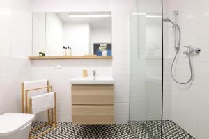 een badkamer met een wastafel en een douche bij Malila Premium Apartments Cracow City Center Pawia 34 in Krakau