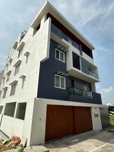 a building with a black and white at Oryx Residences in Mysore