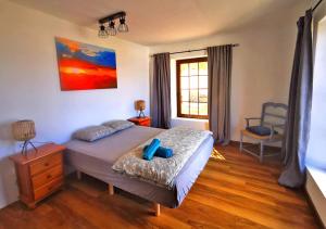 a bedroom with a bed and a window at Casa-la-Costa in La Costa