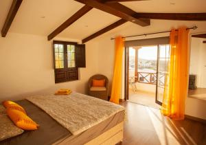 a bedroom with a bed and a balcony at Casa-la-Costa in La Costa +56 photos