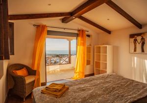 a bedroom with a bed and a view of the ocean at Casa-la-Costa in La Costa
