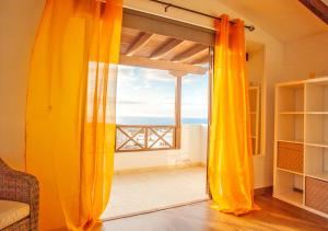a room with a sliding glass door with a view of the ocean at Casa-la-Costa in La Costa