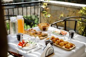 a table with plates of food and drinks on it at Hotel Pashai in Gjirokastër