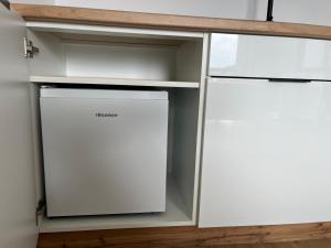 a kitchen with white cabinets and a dishwasher at AMD Apartamenty Ustka *** in Ustka
