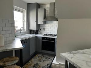 a kitchen with a sink and a stove top oven at Cosy 2 Double Bed Apartment in Swords