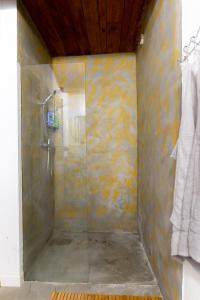 a shower with a glass door in a bathroom at Poklidná Chalupa in Klenovice