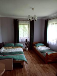 a bedroom with two beds and a window at Miodowe wzgórze in Jastrzębia