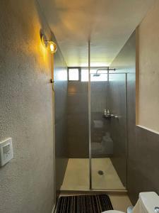 a shower with a glass door in a bathroom at Comfortable Ground Floor Apt with Terrace in Mexico City