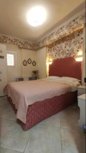 a bedroom with a large bed with a red headboard at Blue Beach Siviri Chalkidiki in Siviri