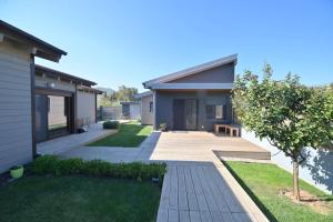 a house with a walkway in front of a house at Schinias beach villa in Schinias