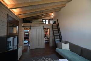 a room with a loft bed and a couch at Schinias beach villa in Schinias