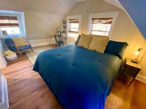 a bedroom with a large blue bed in a room at Jewel Brook Cottage in Ludlow