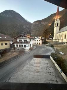 an empty street in a town with a church at Dorfwirt in Mils bei Imst